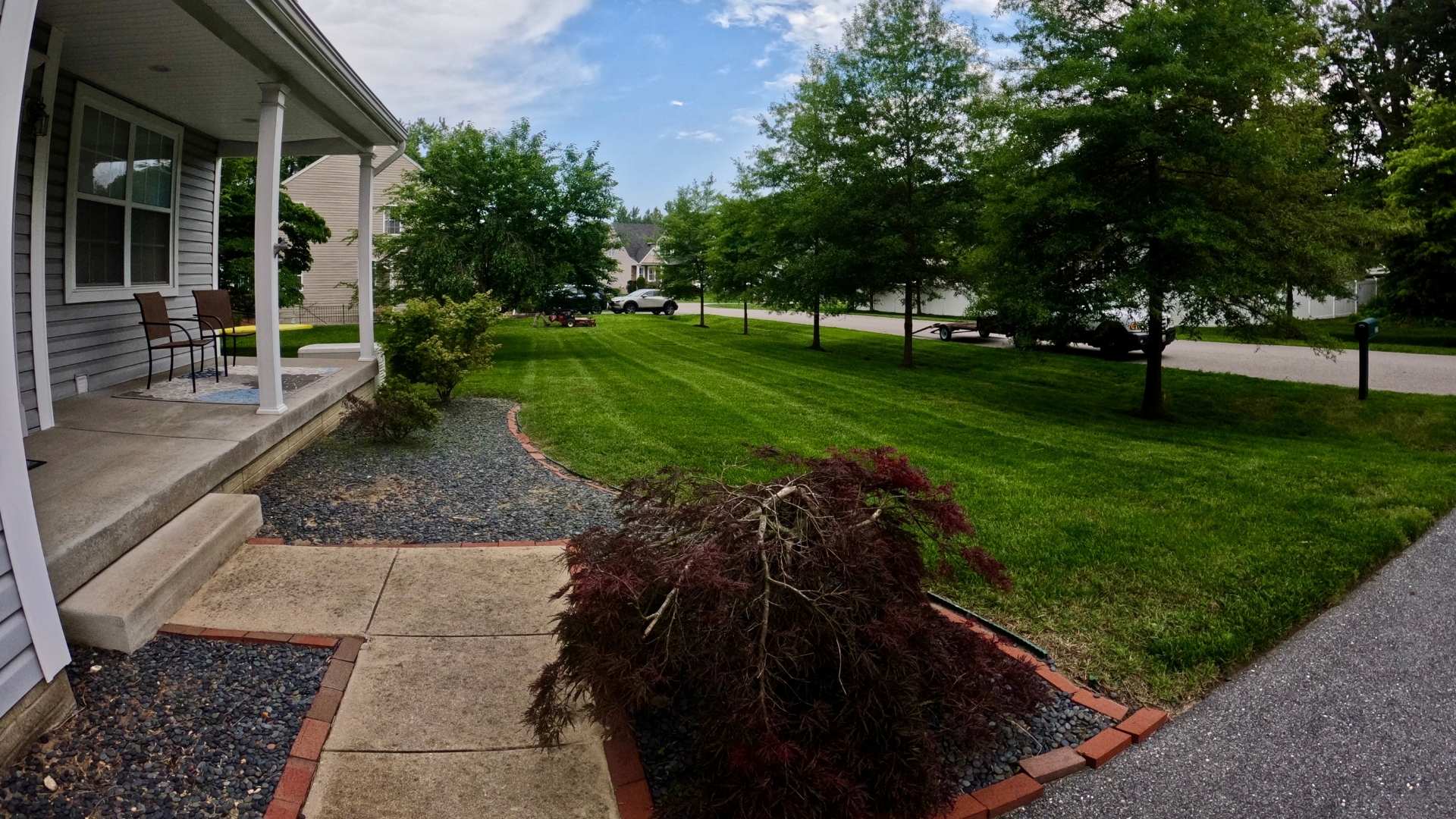Front yard of a house with a driveway, lawn, and trees on Bellemeade Dr, Severna Park, MD.