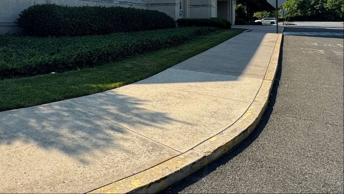 Bowie Town Centers Macy's Building exterior with a sidewalk and grass area at back